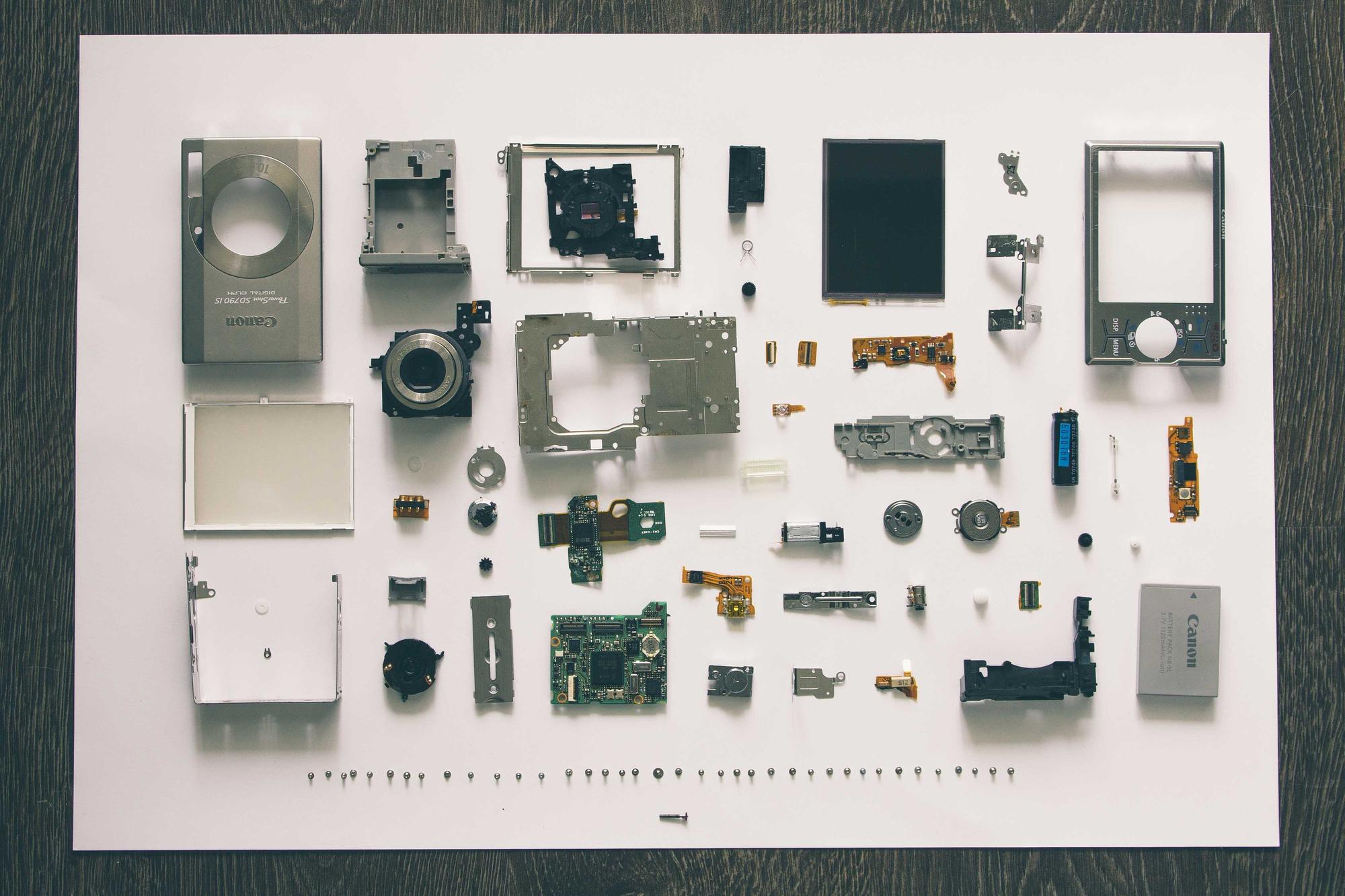 Small electronic parts arranged in a neat grid on white